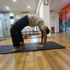 Each student's Chakrasana is unique. My role is to guide them in finding their best expression of the pose, focusing on opening the chest and maintaining steady breath.