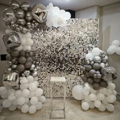 Bring on the party with a fun disco theme. This setup features a silver shimmer wall and disco ball foil balloons, creating the perfect retro-glam atmosphere for a memorable bachelorette or birthday celebration.