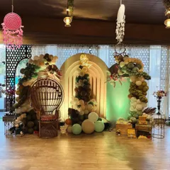 Our signature boho baby shower setup. We combined earthy-toned organic balloon arches with pampas grass and a custom "Oh Baby" neon sign to create a warm, inviting photo zone. The wicker peacock throne makes the mom-to-be the true center of attention.