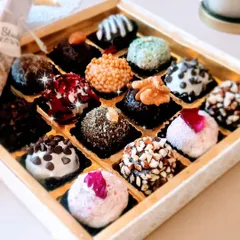 Our assorted chocolate truffles are a popular choice for bulk and corporate orders. This box of 16 includes a wide range of flavors and textures, from nutty to creamy to crunchy.