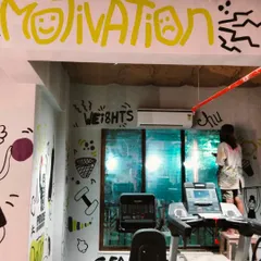 A wider view of the gym, where my doodle art covers the walls and ceiling, creating an immersive, high-energy environment. You can see me on a stool, adding the final touches.