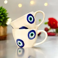 A set of beautiful ceramic cups, each hand-painted with the protective evil eye motif. They are perfect for serving drinks during festive gatherings or as a unique gift that blends utility with tradition.