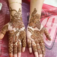 This is a great example of a simple yet elegant party mehendi. The design focuses on a bold rose pattern with leafy vines, perfect for guests at any event.