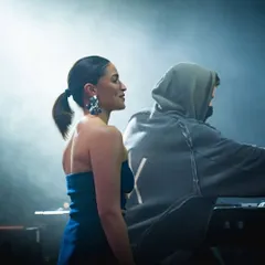 A candid moment between Alia Bhatt and Alan Walker on stage, enjoying the incredible atmosphere.
