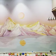 This is a serene mountain landscape mural I painted for a client's home. The soft, pastel colors of the sunset reflect on the water, creating a peaceful and calming atmosphere in the room.