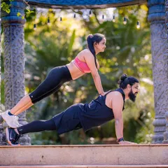 A playful take on a partner workout. This shot is full of energy and shows the couple's fun-loving and supportive relationship.