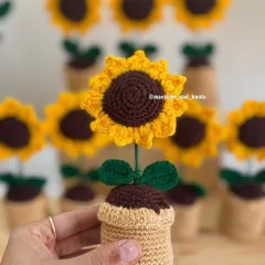 A close-up of my potted crochet sunflower, a cheerful and charming gift that's perfect for brightening up a desk or a small space. I make these in large batches for return favors.