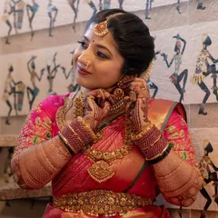 A glowing bride in her vibrant pink saree, showcasing her intricate Bridal Extravaganza mehendi. Her happy expression says it all.