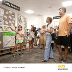 Our Grade 3 Courage Museum in action. A student presents her exhibit, sharing stories of courageous individuals she researched. This project integrates reading, writing, and social studies, empowering students to find and share their voices.
