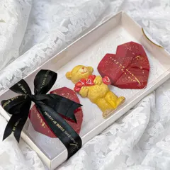 This cute Valentine's hamper includes two red velvet heart-shaped cakesicles and a little teddy bear. It's a small, sweet gesture of love, packed and tied with a bow.