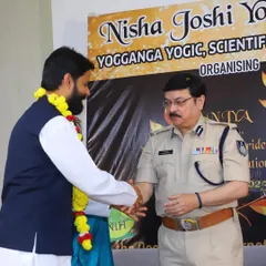 Receiving the Yog Ratna Award in Indore from a senior police official at an event by the Nisha Joshi Yoga Academy.