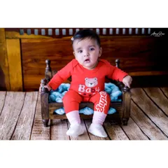 Meet Navya, Anika's twin sister! Dressed in a cute red outfit, she sits like a pro for her sitter session portrait. It's a joy to capture the unique personalities of each child.