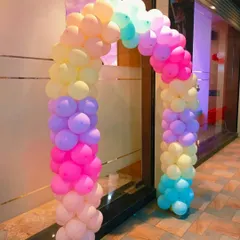 A bright and cheerful balloon arch in a rainbow of pastel colors. This decoration is perfect for adding a pop of color to the entrance of a birthday party or baby shower venue.