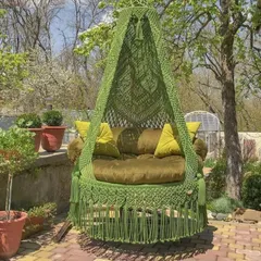 Swinging through life in the garden. Our green macrame swing blends beautifully with nature, creating a peaceful and relaxing outdoor retreat.