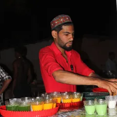 Our staff preparing trays of colorful welcome drinks. We offer a variety of juices and mocktails to ensure guests feel refreshed and welcomed as they arrive.