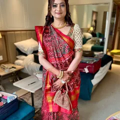 A full look showing the elegant makeup and traditional Patola saree. She looks graceful and ready for the wedding festivities.