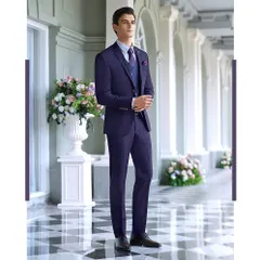 A deep blue three-piece suit styled for a Louis Philippe shoot. The composition in a classic colonnade highlights the suit's structure and rich color, presenting a powerful and polished look for formal business or evening wear.