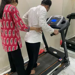 Here, I am guiding a patient through gait training on the treadmill. This is a crucial part of rehabilitation for many lower back and leg injuries, helping to restore correct movement patterns, build strength, and regain confidence with every step.