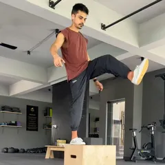 Working on single-leg balance and strength with a pistol squat progression on a box. This kind of unilateral work is great for identifying and fixing imbalances.