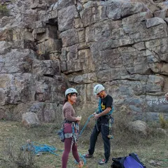 Safety first, always. We ensure everyone is comfortable with their gear, like these climbers preparing for a route with helmets and harnesses at the ready.