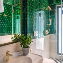 Can you feel the gentle caress of emerald hues and vintage whispers? In this powder room, I paired classic green subway tiles with a vintage-style sink and gold fixtures to create a sanctuary where past meets present.