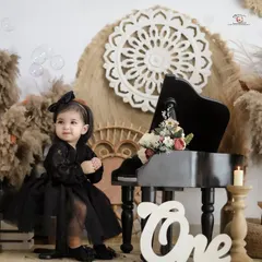 Capturing a moment of wonder as bubbles float by during a first birthday photoshoot. The soft lighting and boho elements add a touch of magic to the scene.