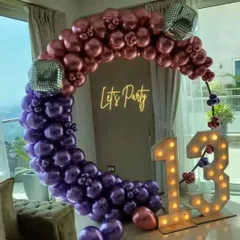 A fun and trendy "Let's Party" theme for a 13th birthday. The two-tone balloon ring, disco ball accents, and marquee numbers create a perfect disco vibe.