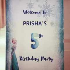 The personalized welcome sign for Prisha's Frozen party, designed with a frosty, snowflake-covered border.
