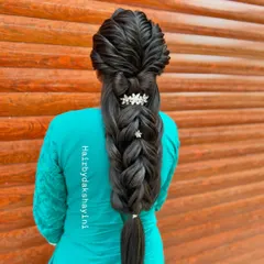 A beautiful and complex five-strand braid, adorned with delicate floral accessories. This is a popular choice for engagements and pre-wedding events.