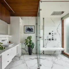 A spacious, light-filled bathroom in the Kanasu residence. We used large-format marble tiles for a luxurious feel and included a skylight in the shower area to bring in natural light while maintaining privacy.