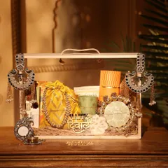 This yellow and green themed Diwali hamper is perfect for a vibrant and cheerful gift. It includes a mix of modern and traditional items, decorated with beautiful silver ethnic hangings.
