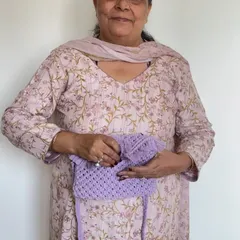 Here I am with a lovely lavender macrame sling bag. We charge a little extra for linings because we custom source the fabric to match your chosen color and hand stitch it.