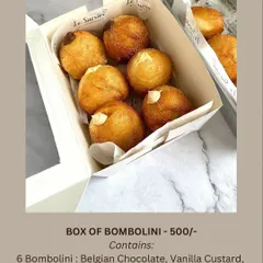 A box of my Italian Bombolini donuts, filled with assorted creams. This box contains two each of Belgian Chocolate, Vanilla Custard, and Coffee Cream.