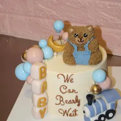 We can "bearly" handle the cuteness of this baby shower cake. It features a hand-sculpted teddy bear, pastel balloons, baby blocks, and a little toy train, all made from fondant and buttercream.