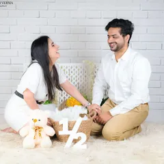 A candid moment of laughter between parents during their baby's half-birthday shoot. It shows that even the in-between moments are beautiful.