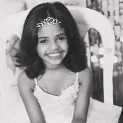 The pure, unfiltered joy of childhood. This black and white portrait of a young girl celebrating a milestone is a perfect example of a memory documented in its rawest form. These are the moments, the genuine smiles, that I live to capture for families to hold onto forever.