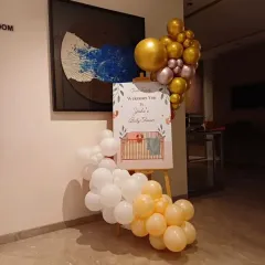 A personalized welcome easel is a great way to greet guests. For this baby shower, I designed a custom sign and decorated it with a matching balloon cluster.
