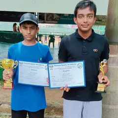 The winner and runner-up of the AITA CS7 Boys U14 singles event holding their certificates and trophies. We manage competitive tournaments that attract top junior talent from across the region.