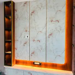 A full view of a floating TV unit with a high-gloss marble laminate finish. The design includes a vertical display cabinet with internal lighting and warm ambient light from underneath the console.