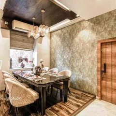 A closer view of the dining area from image 18, highlighting the dark wood table, textured chairs, and a unique wooden door against a textured wall.
