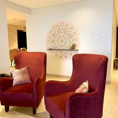 This gold and blush mandala mural was designed as a calming centerpiece for a cozy reading corner, placed perfectly between two comfortable armchairs.