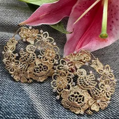 These large hoops are handcrafted in 18k gold to resemble intricate lace, with birds and flowers woven into the design. Sprinkled with natural diamonds, they are both casual and smart, perfect for any occasion.