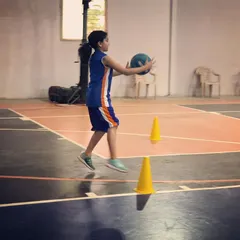 A young player practices her jump-stop during a drill. We focus on teaching proper footwork early to build a strong foundation for more advanced moves later on.