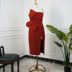 This red dress is for someone who loves a classic silhouette with a hint of drama. The oversized 3D flower adds a unique, sculptural element to the design.