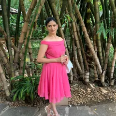 Another shot of the custom pink off-shoulder dress. The fit-and-flare style is universally flattering, and the lightweight fabric makes it comfortable for any celebration.