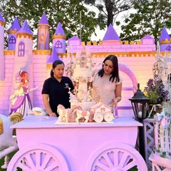 Another view of the on-site setup, making sure the princess castle cake is perfectly positioned.