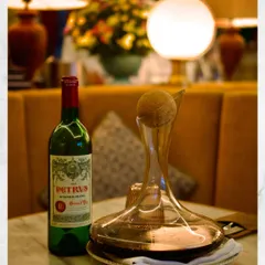 A bottle of Petrus Pomerol, decanted and ready to be enjoyed. Our underground wine cellar houses some truly special bottles for those looking for a remarkable wine experience.
