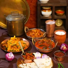 An authentic Maharashtrian thali spread, rich with traditional dishes like Bharli Vangi and Bhakri, served in classic brass and copperware. This image evokes a sense of home-cooked warmth and cultural heritage, inspired by my travels in rural Maharashtra.