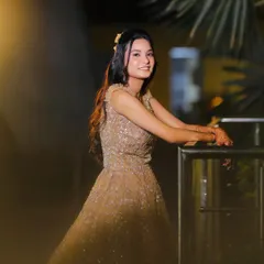 A candid shot of the engagement look. The half-up hairstyle with a simple accessory adds a touch of modern elegance.