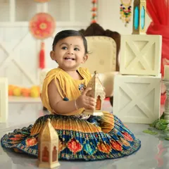 A smile that shines brighter than any diya! This little girl in a beautiful traditional outfit is all joy during our special Diwali-themed photoshoot.